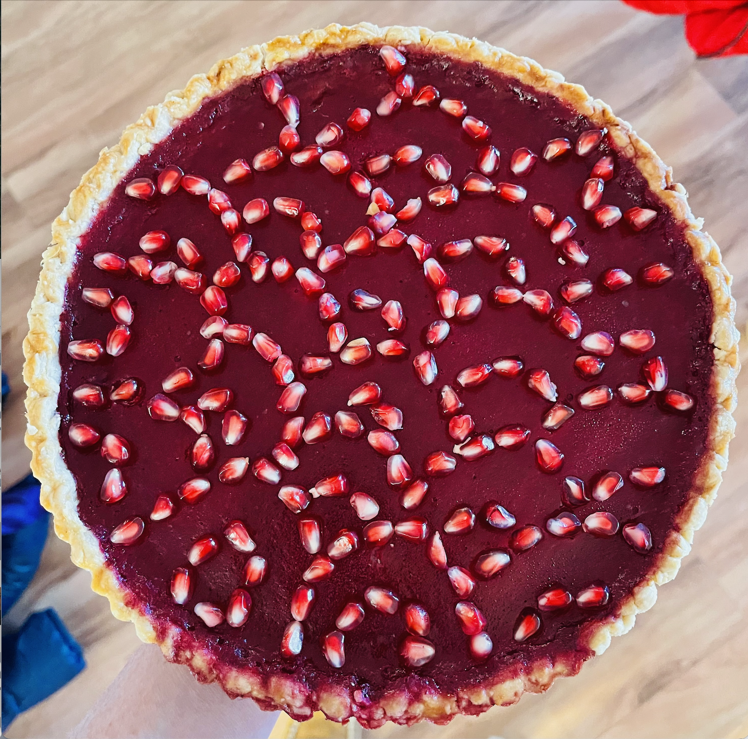 Bright magenta tart covered with pomegranate aril design