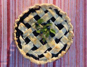 Wild blueberry pie with a lattice top and a blueberry leaf on top