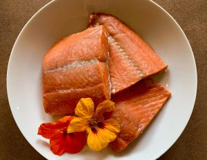 smoked salmon and an orange flower in a bowl