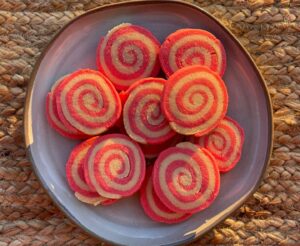 red and white pinwheel cookies on a plate
