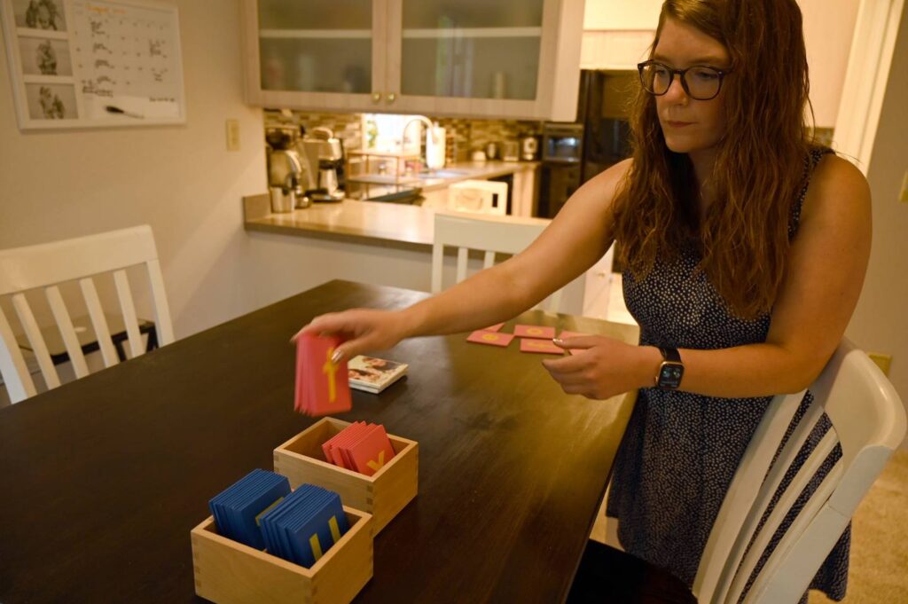 woman putting cards into a box on a table
