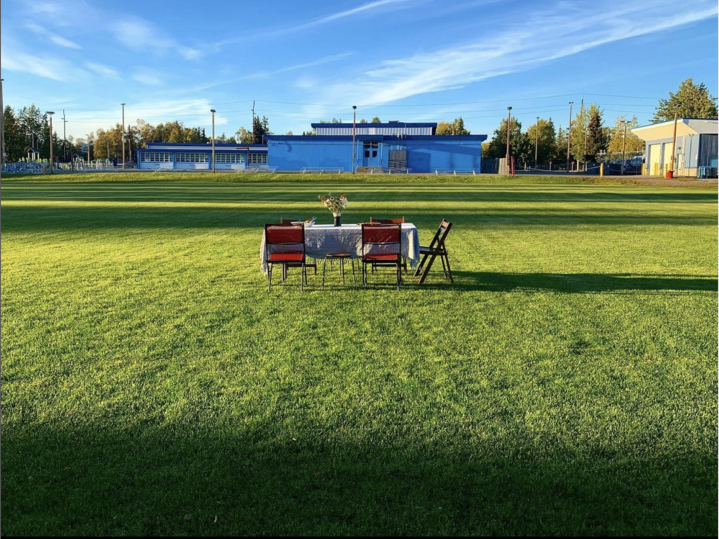 table set in a grassy field