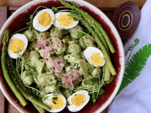 Green potato salad with asparagus, boiled eggs and pickled shallots